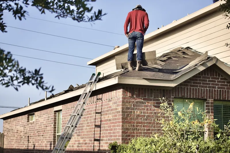 Professional roofer working on a residential roof in Oehlmann Park